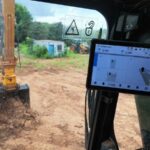 T10 tablet in an excavator cab showing left, middle and right cut/fill while the bucket digs